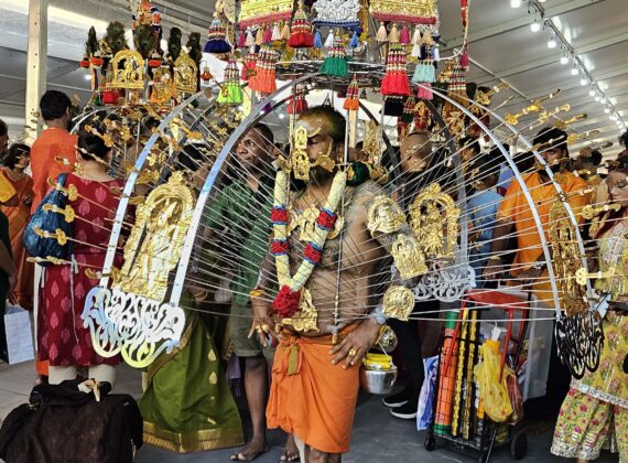 Devotees carrying elaborately decorated kavadis during Thaipusam procession at Holy Tree Sri Balasubramaniar Temple.